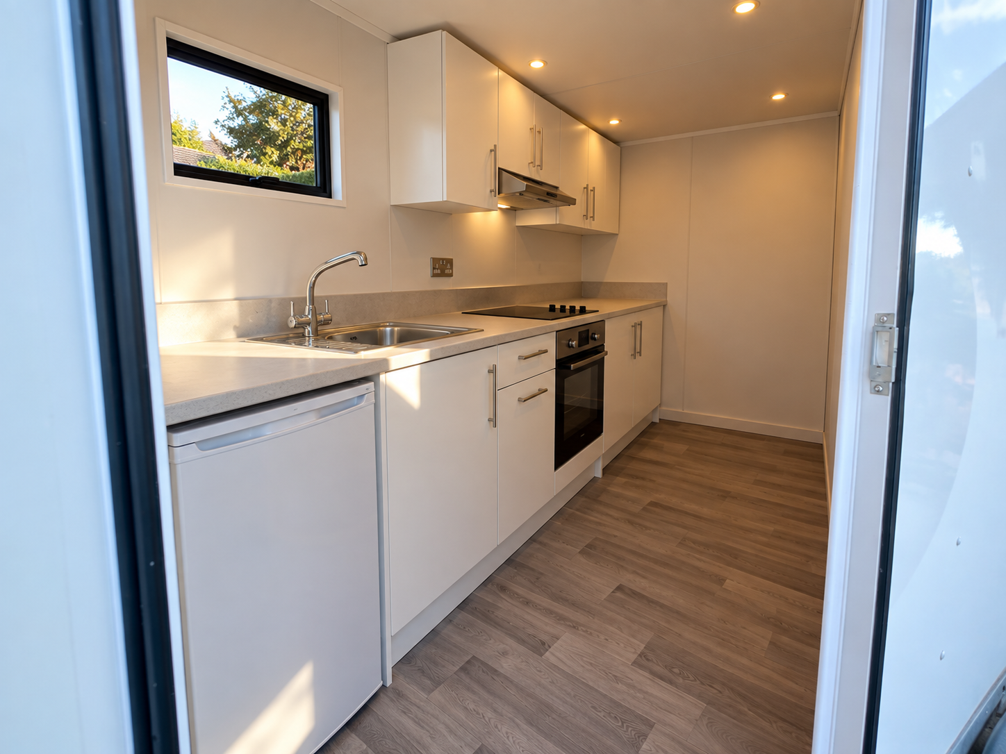 Wide view of the bright Kitchen Flex trailer interior